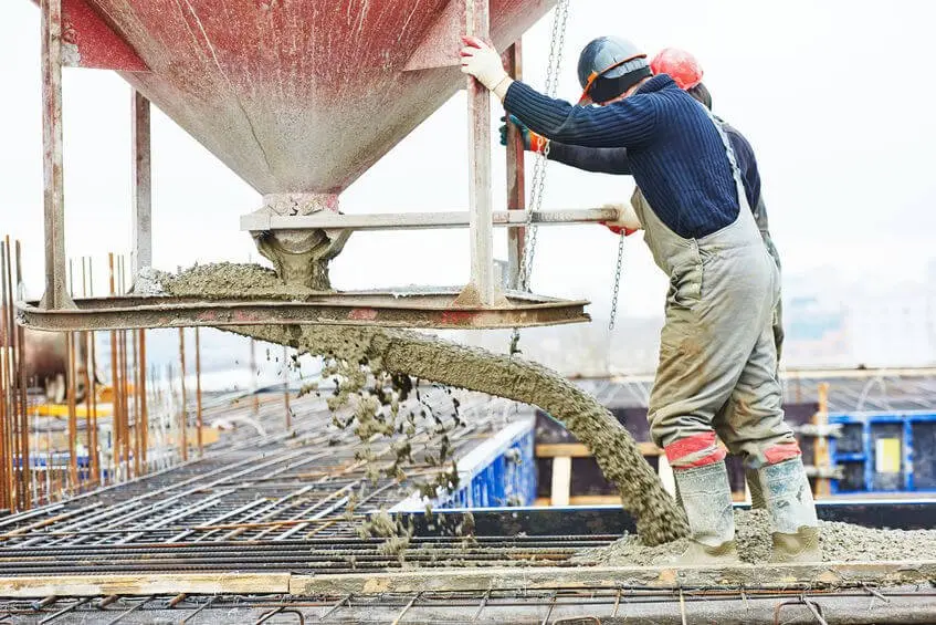 Concrete contractor workers pouring a foundation
