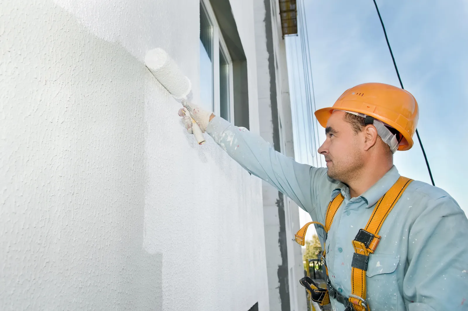 Commercial painter painting a building exterior