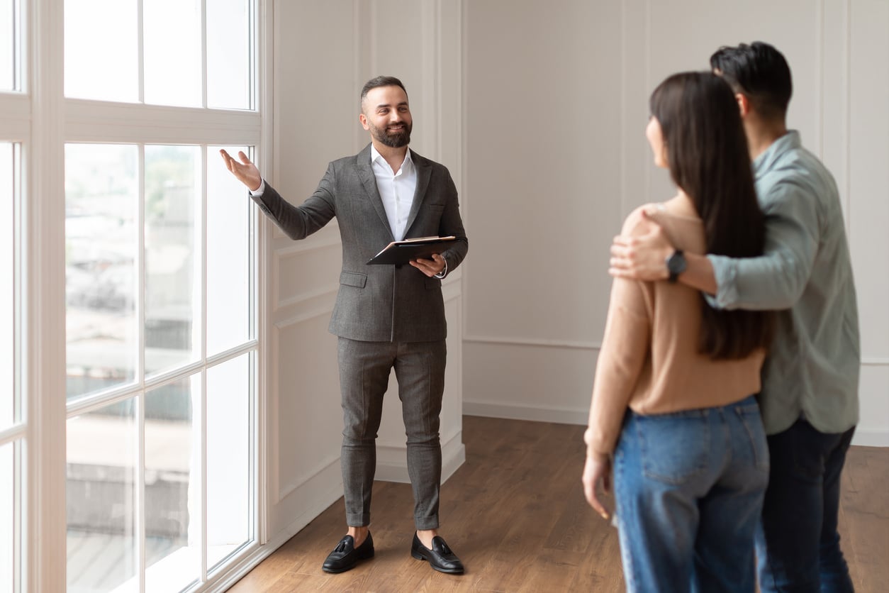Real estate agent showing property to clients